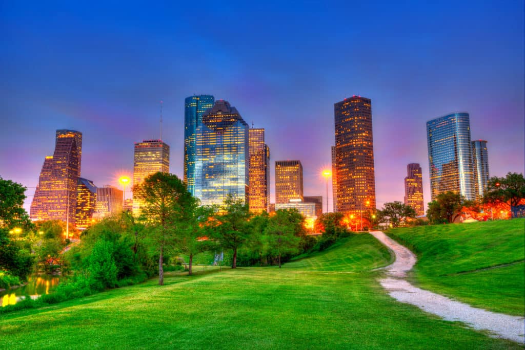 Houston Texas modern skyline at sunset twilight on park Houston Texas modern skyline at sunset twilight from park lawn HDRI